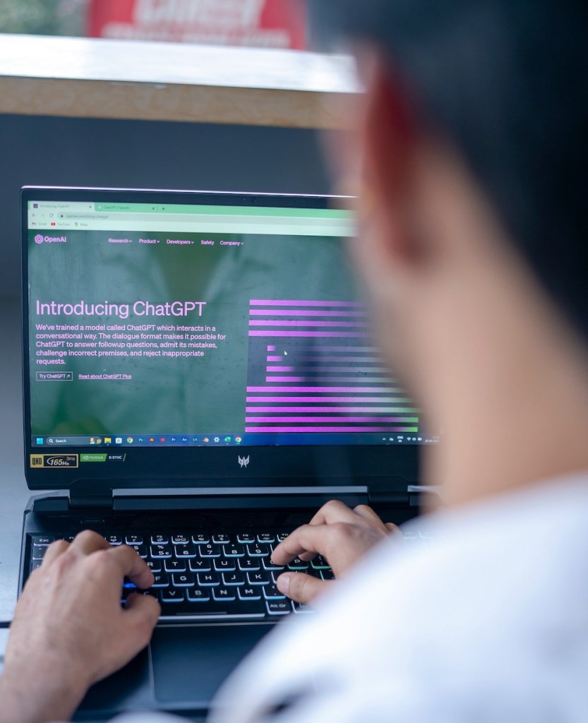 Man with laptop open to ChatGPT